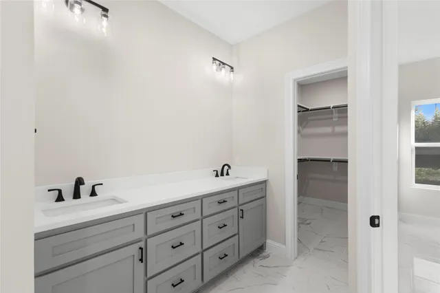 a bathroom with a double vanity sink and mirror