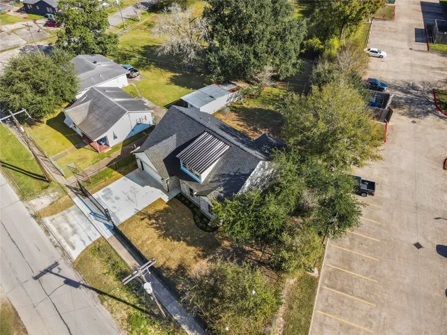 an aerial view of a house with a yard