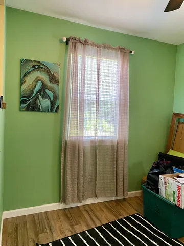 a view of a room that has a yard and a window