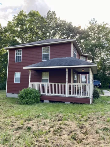 a front view of a house with garden