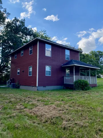 a view of a large brick house with a yard