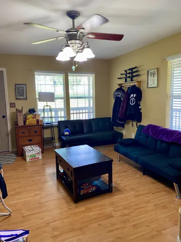 a living room with furniture and a chandelier
