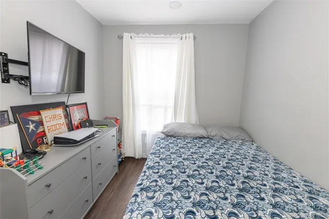 a bedroom with a bed and flat screen tv