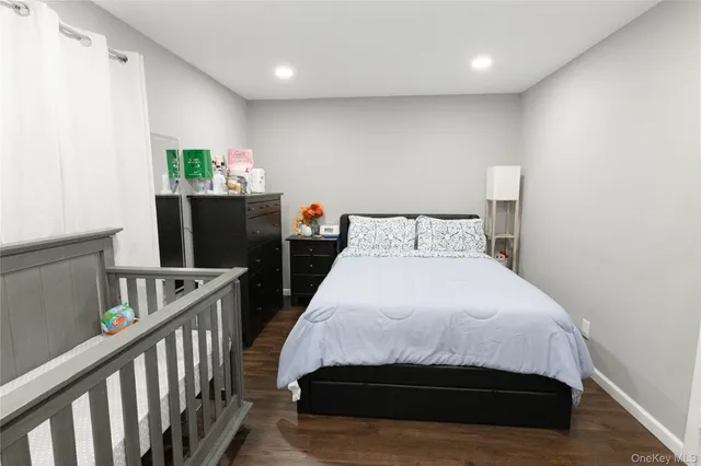 a bedroom with bed and flat screen tv