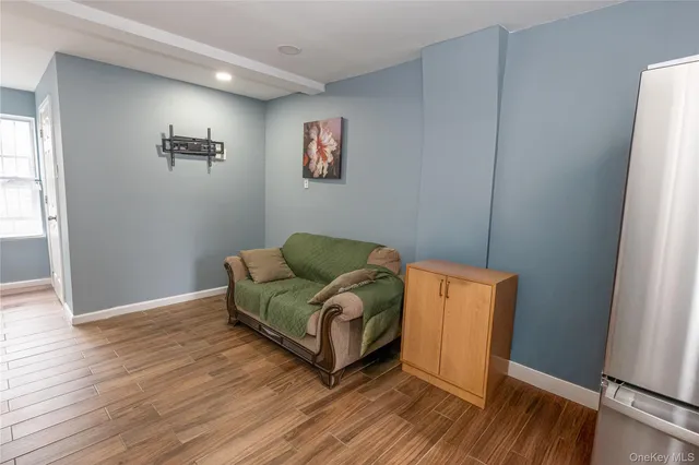 a living room with hard wood floors and a window