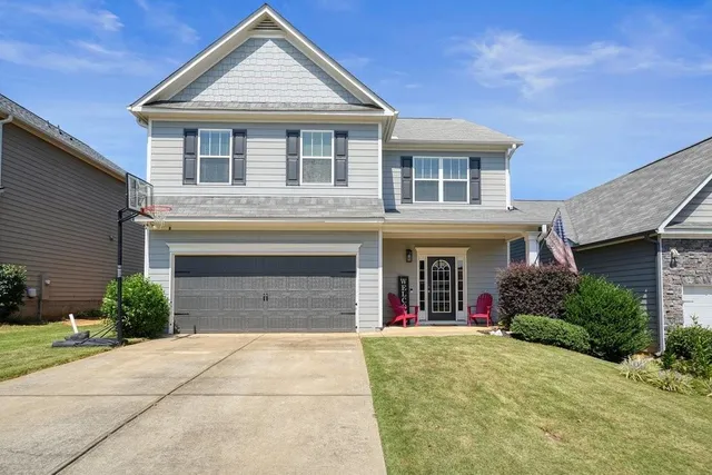 a front view of a house with yard and garage