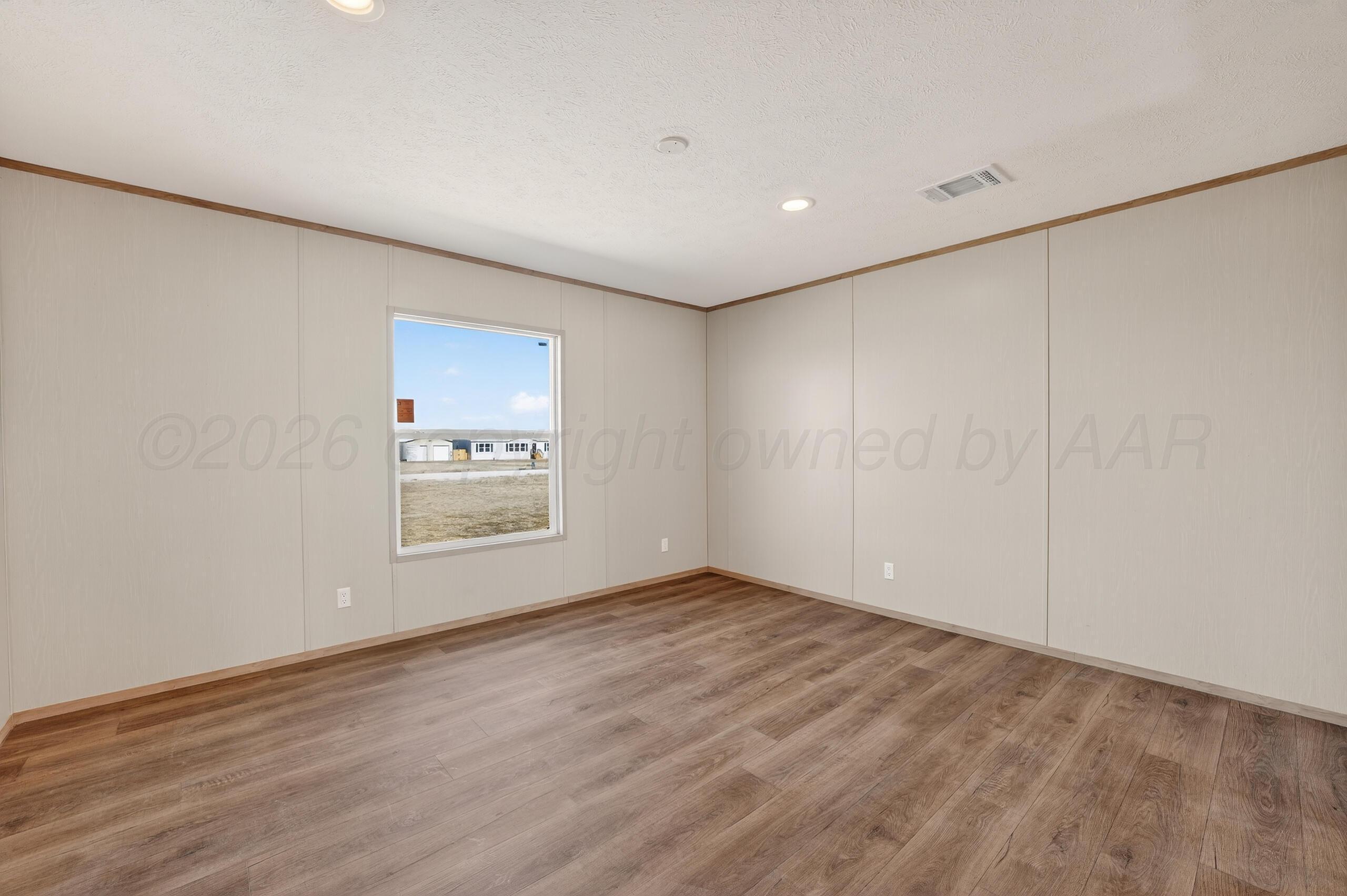 2680 Avery Rd Canyon Canyon, TX 79015 - Photo 13 of 35 a view of an empty room with wooden floor and a window