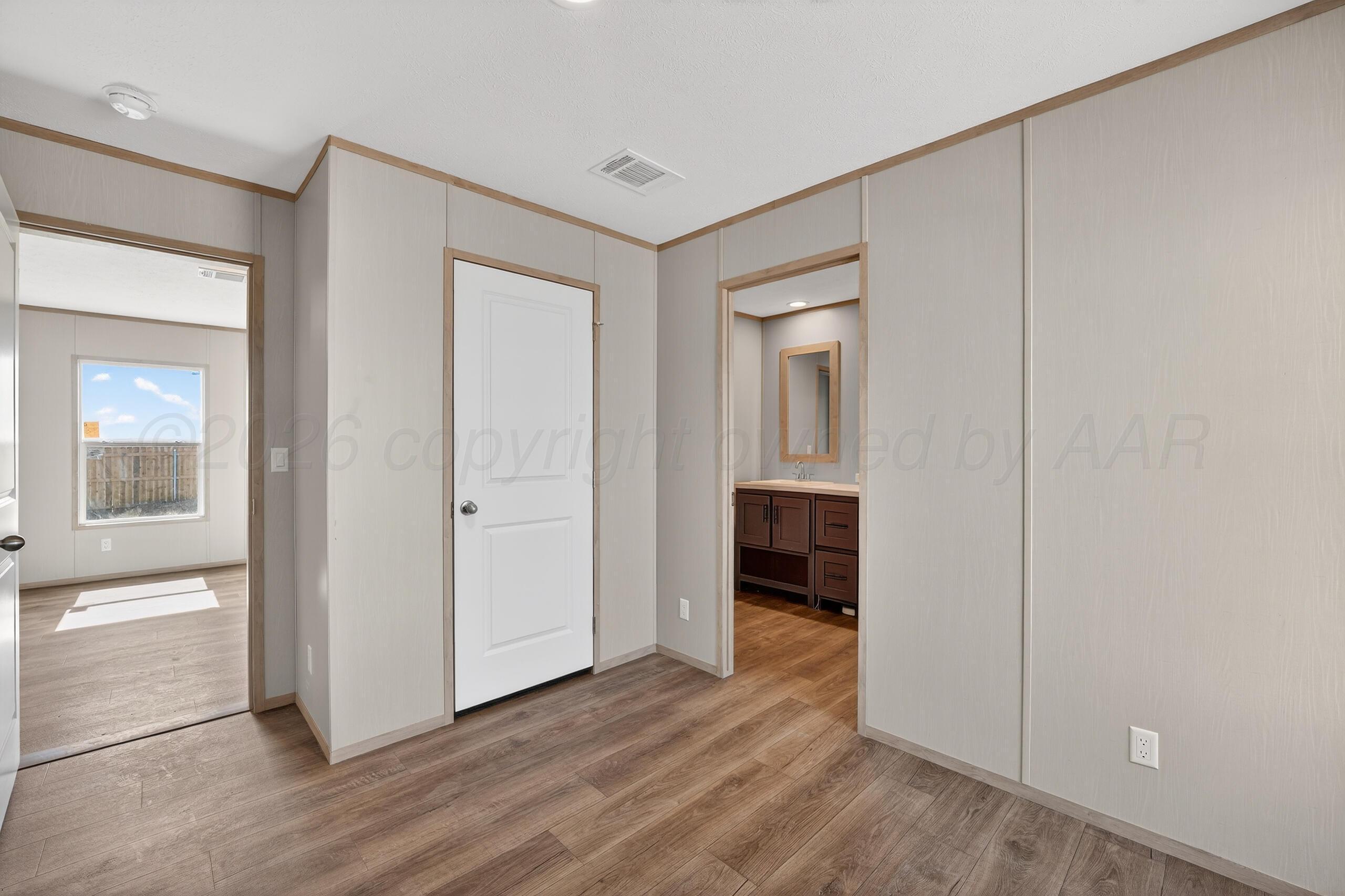 2680 Avery Rd Canyon Canyon, TX 79015 - Photo 18 of 37 an empty room with wooden floor and cabinet