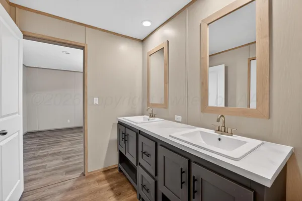 a bathroom with a double vanity sink and a mirror