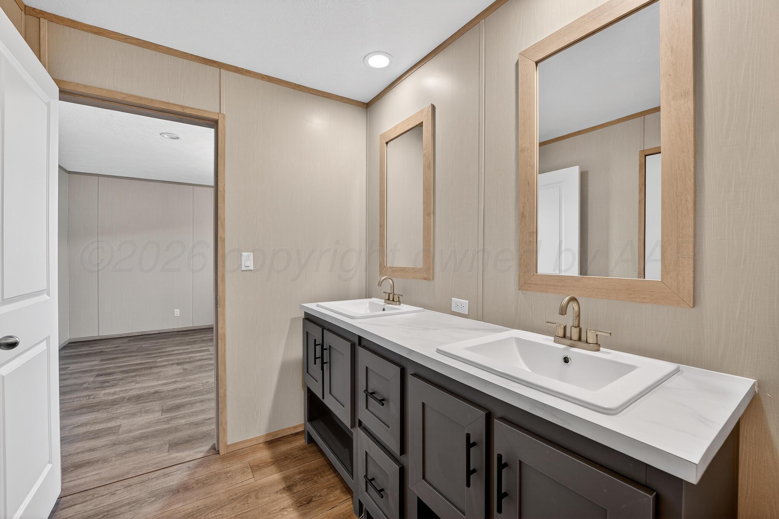 2680 Avery Rd Canyon Canyon, TX 79015 - Photo 20 of 35 a bathroom with a double vanity sink and a mirror