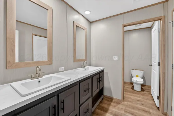 a spacious bathroom with a sink and a mirror
