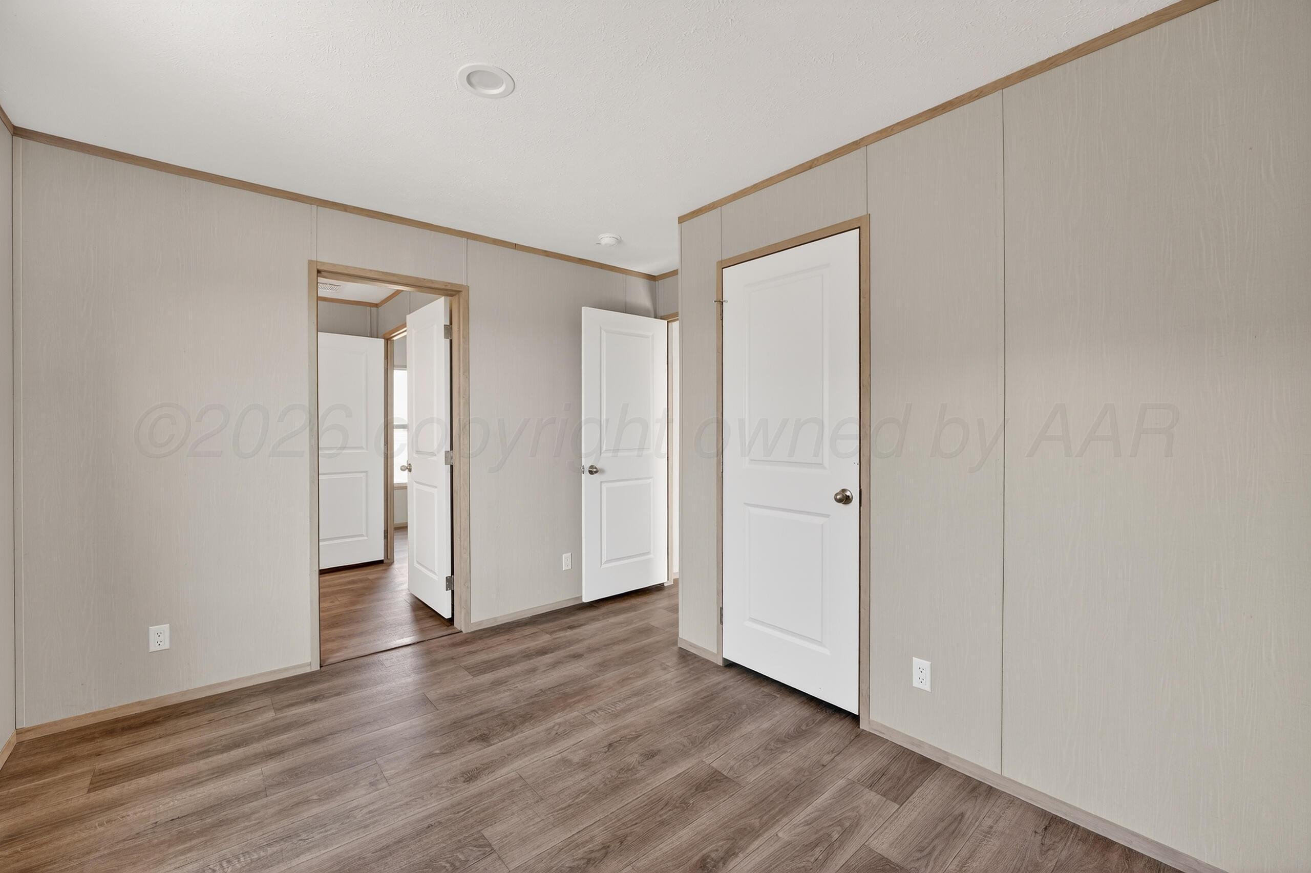 2680 Avery Rd Canyon Canyon, TX 79015 - Photo 23 of 35 a view of an empty room with wooden floor and closet