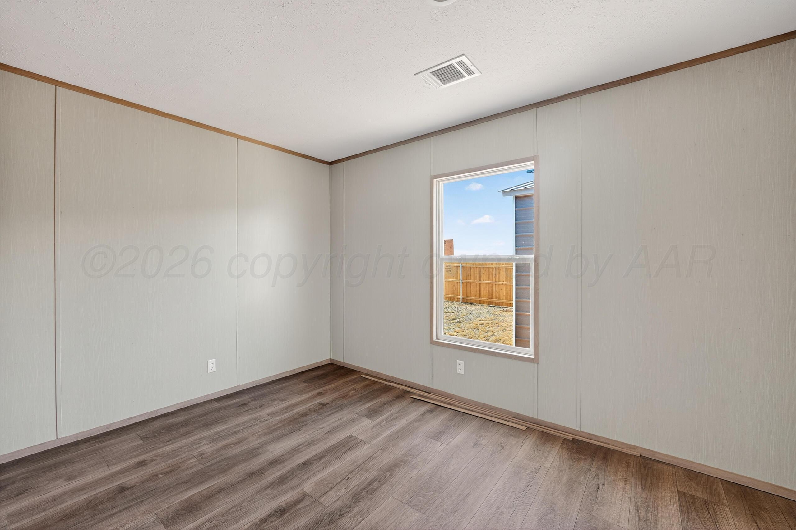 2680 Avery Rd Canyon Canyon, TX 79015 - Photo 23 of 37 an empty room with wooden floor and windows