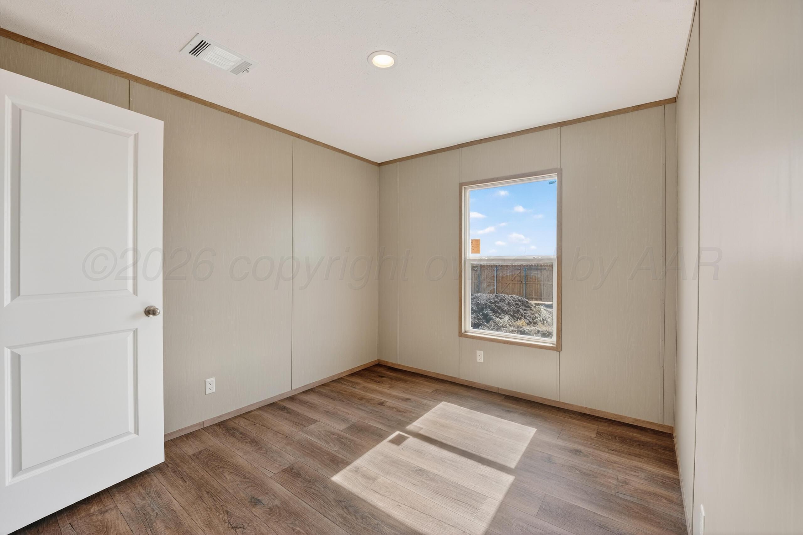 2680 Avery Rd Canyon Canyon, TX 79015 - Photo 26 of 37 an empty room with wooden floor and windows