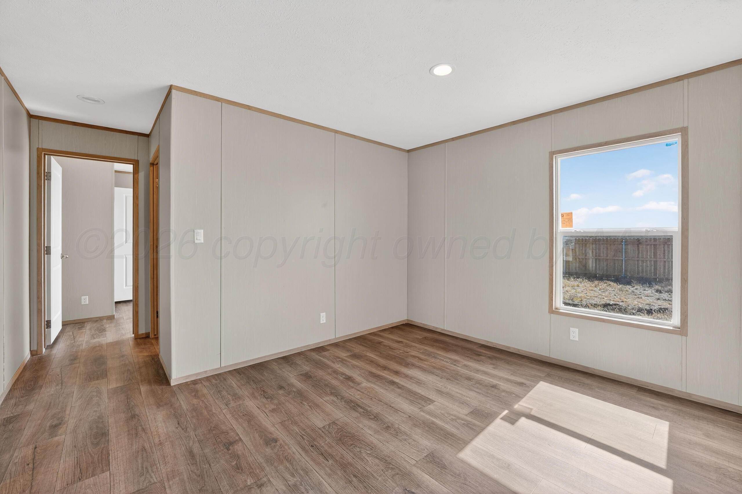 2680 Avery Rd Canyon Canyon, TX 79015 - Photo 29 of 35 a view of an empty room with wooden floor and a window