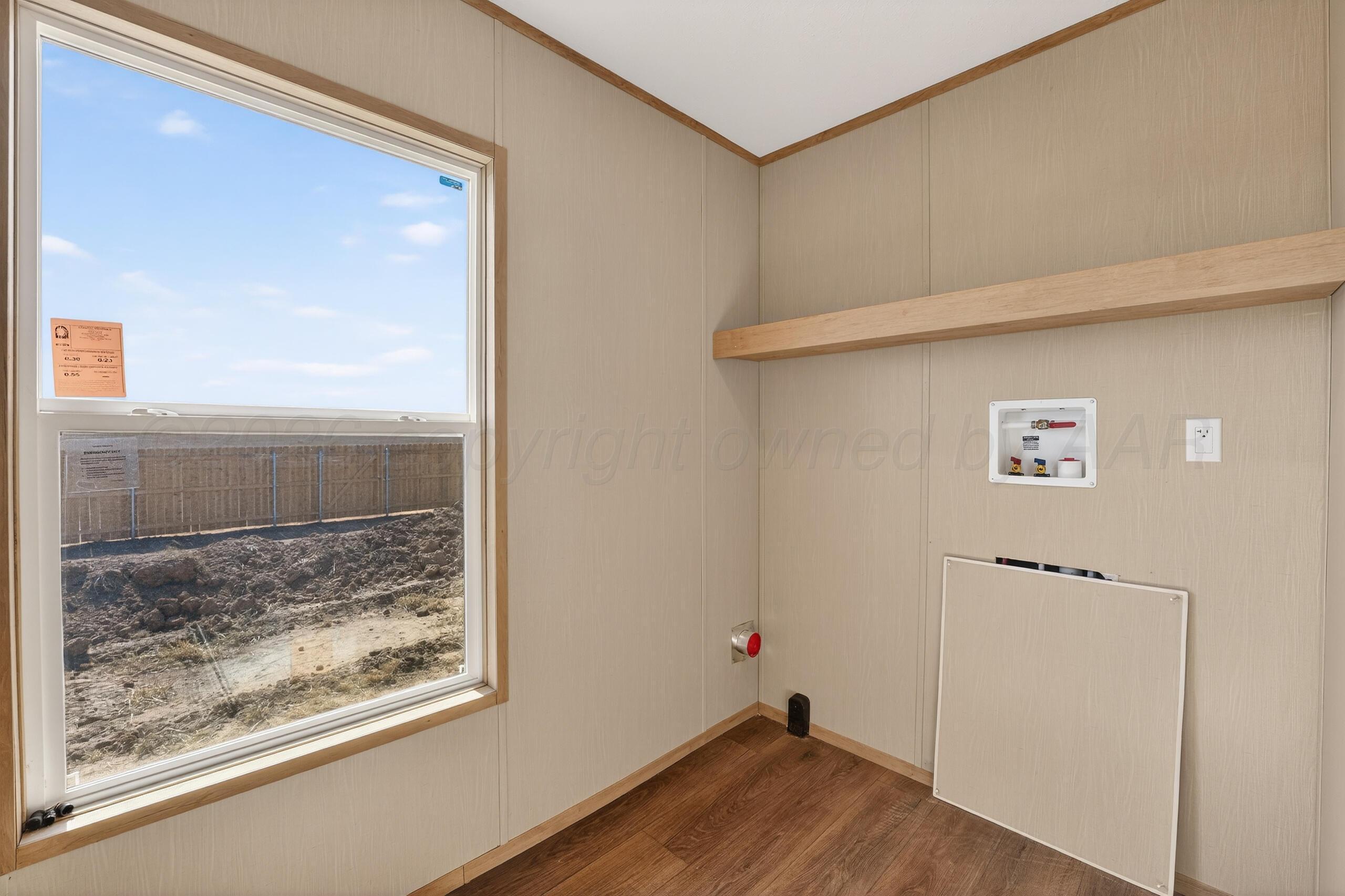 2680 Avery Rd Canyon Canyon, TX 79015 - Photo 32 of 35 a view of a hallway with wooden floor and a cabinet