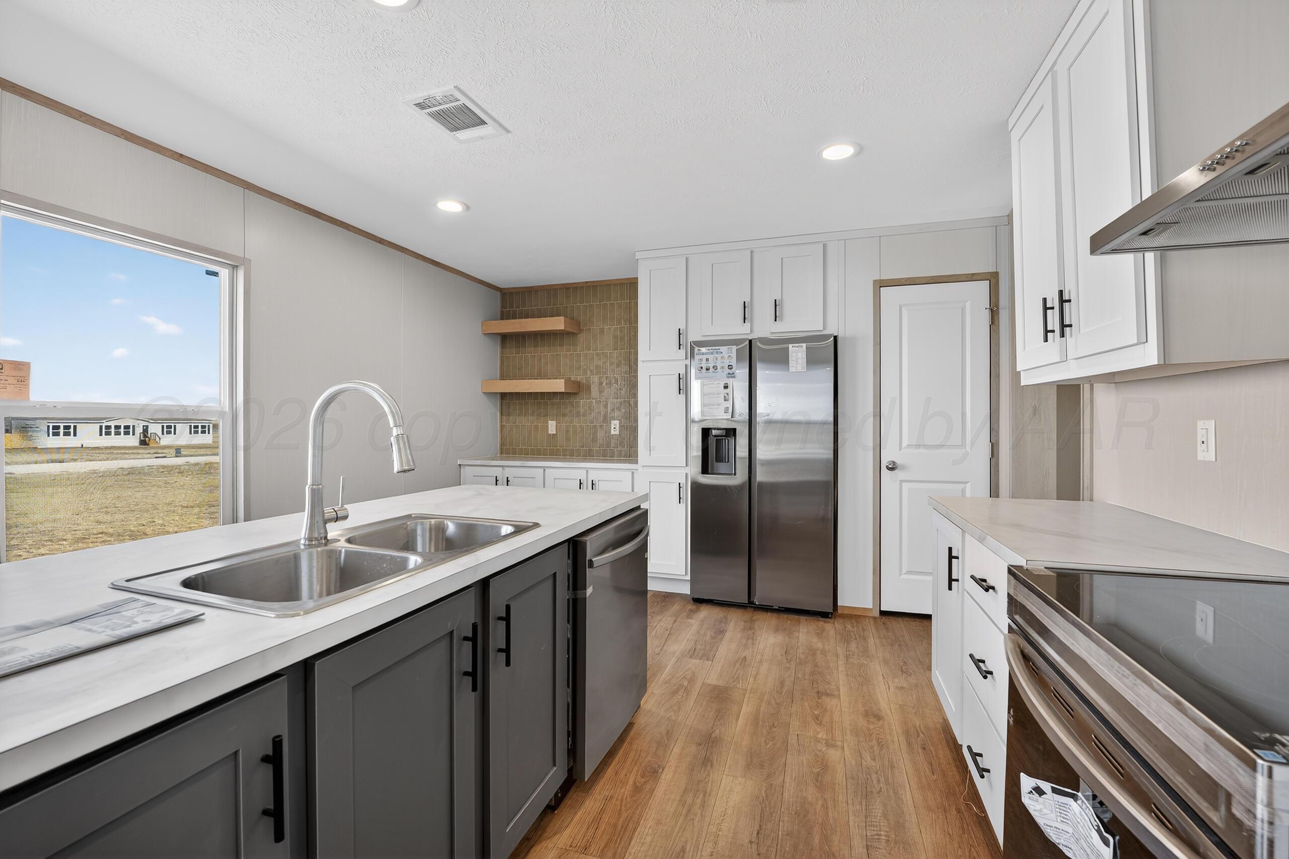 2680 Avery Rd Canyon Canyon, TX 79015 - Photo 6 of 35 a kitchen with stainless steel appliances granite countertop a sink stove and refrigerator