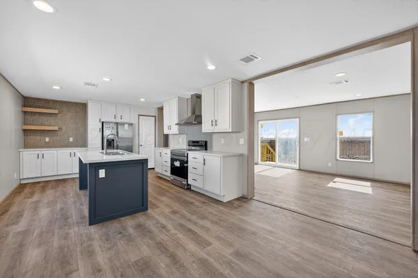 a large kitchen with wooden floors and white stainless steel appliances