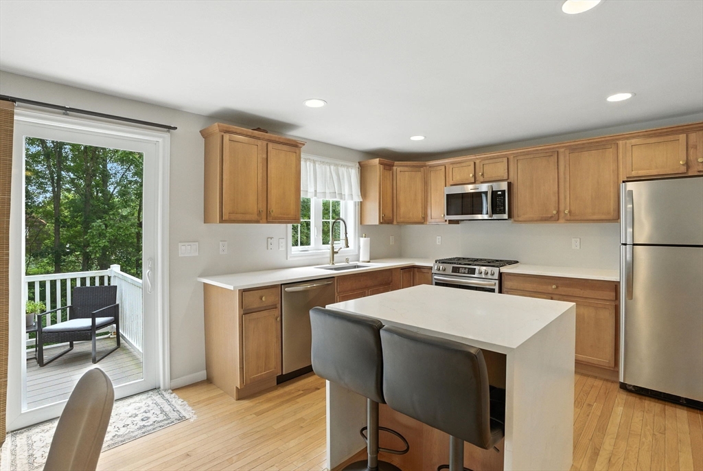 2 Sandpiper Way, Unit A Salisbury, MA 01952 - Photo 3 of 30 a kitchen with refrigerator cabinets and wooden floor
