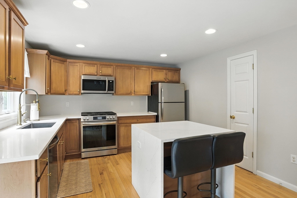 2 Sandpiper Way, Unit A Salisbury, MA 01952 - Photo 7 of 30 a kitchen with refrigerator cabinets and wooden floor