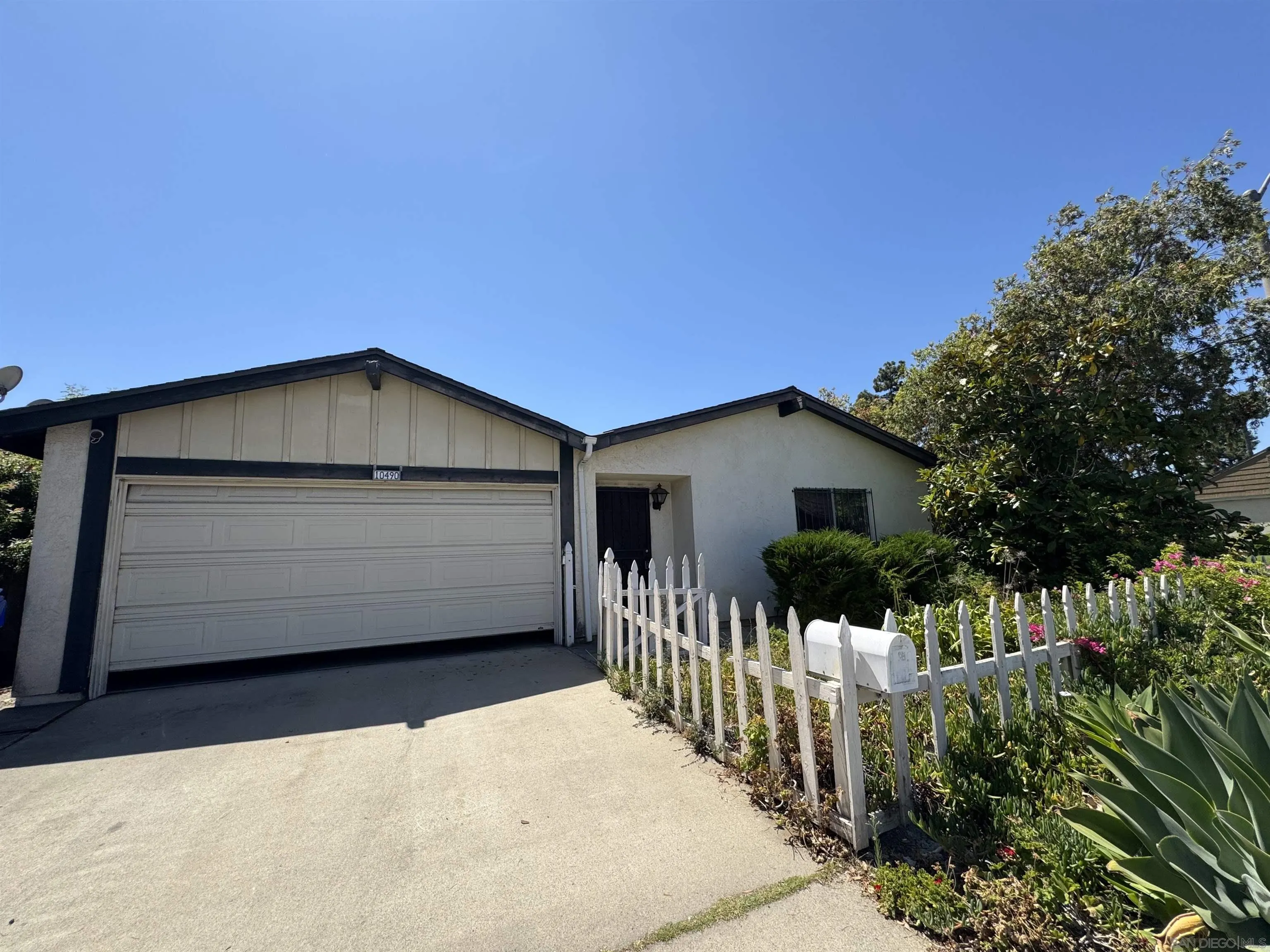 a front view of house with wooden fence