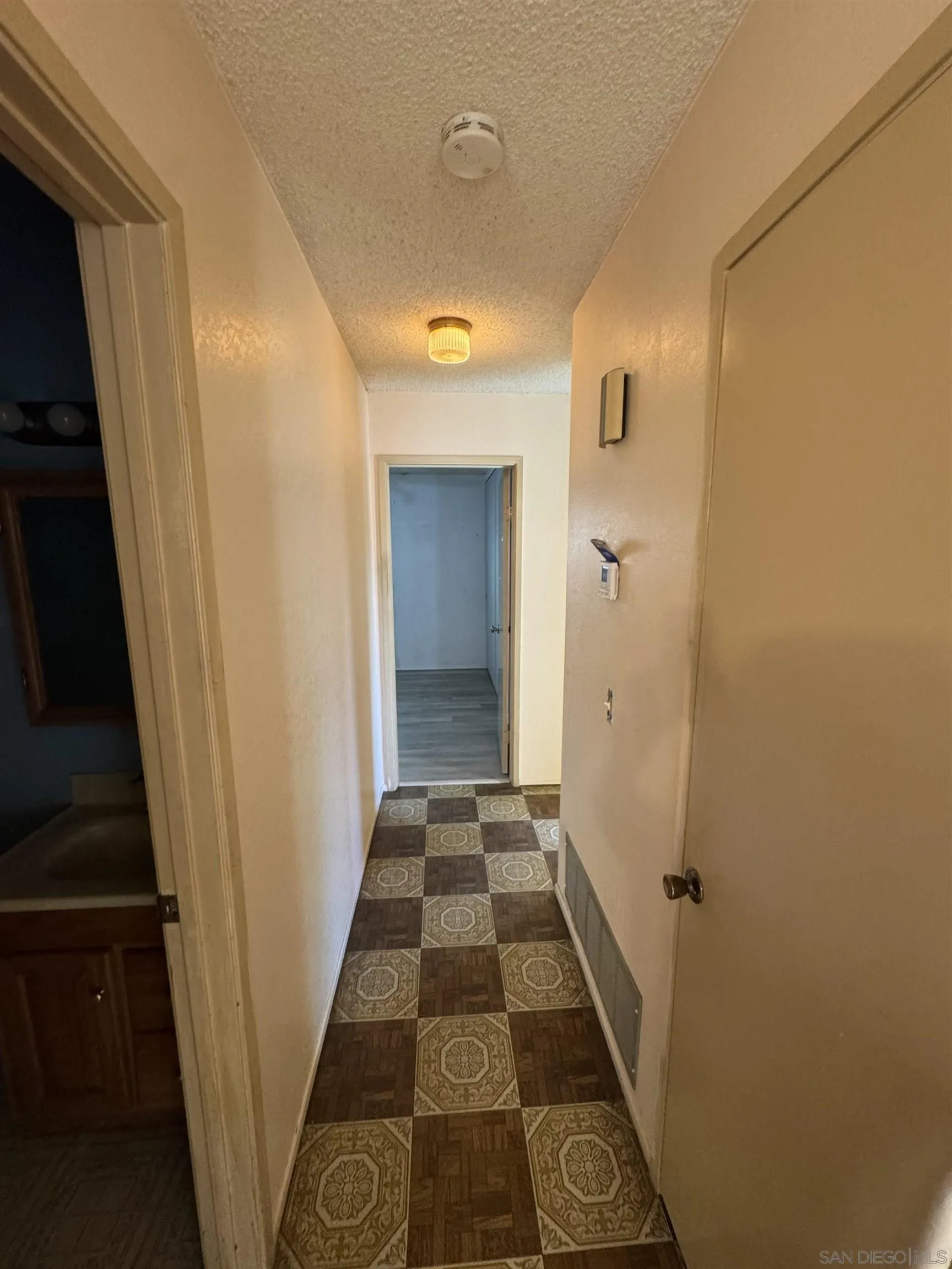 10490 Stanfield Circle San Diego, CA 92126 - Photo 14 of 21 a view of a hallway with wooden floor and staircase