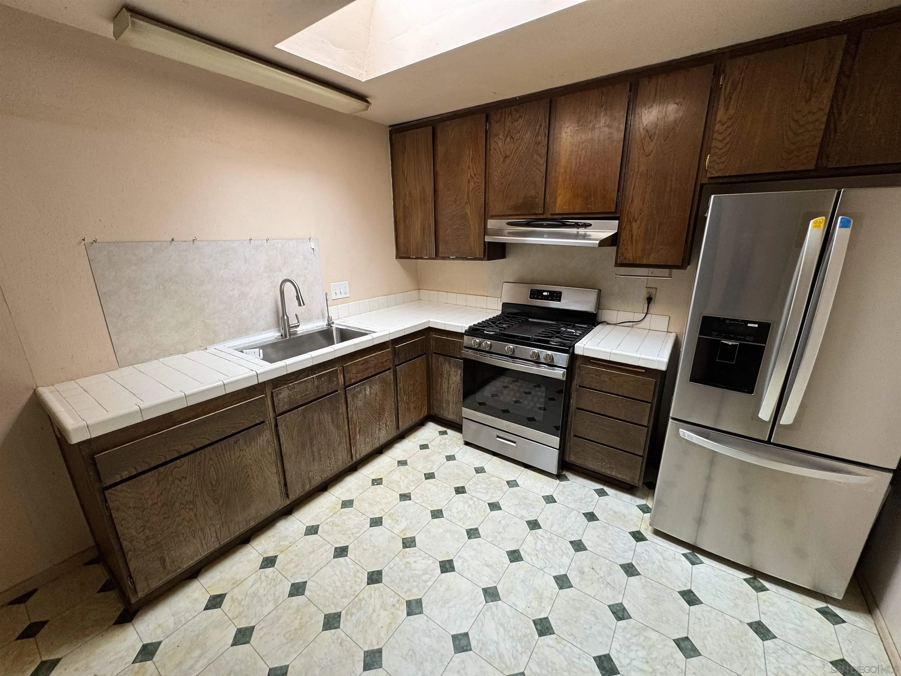 10490 Stanfield Circle San Diego, CA 92126 - Photo 7 of 21 a kitchen with a sink appliances and cabinets