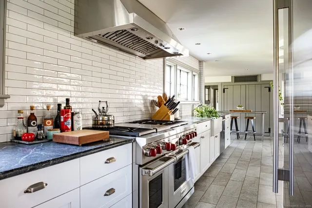 a front view of a house with garden and sitting area