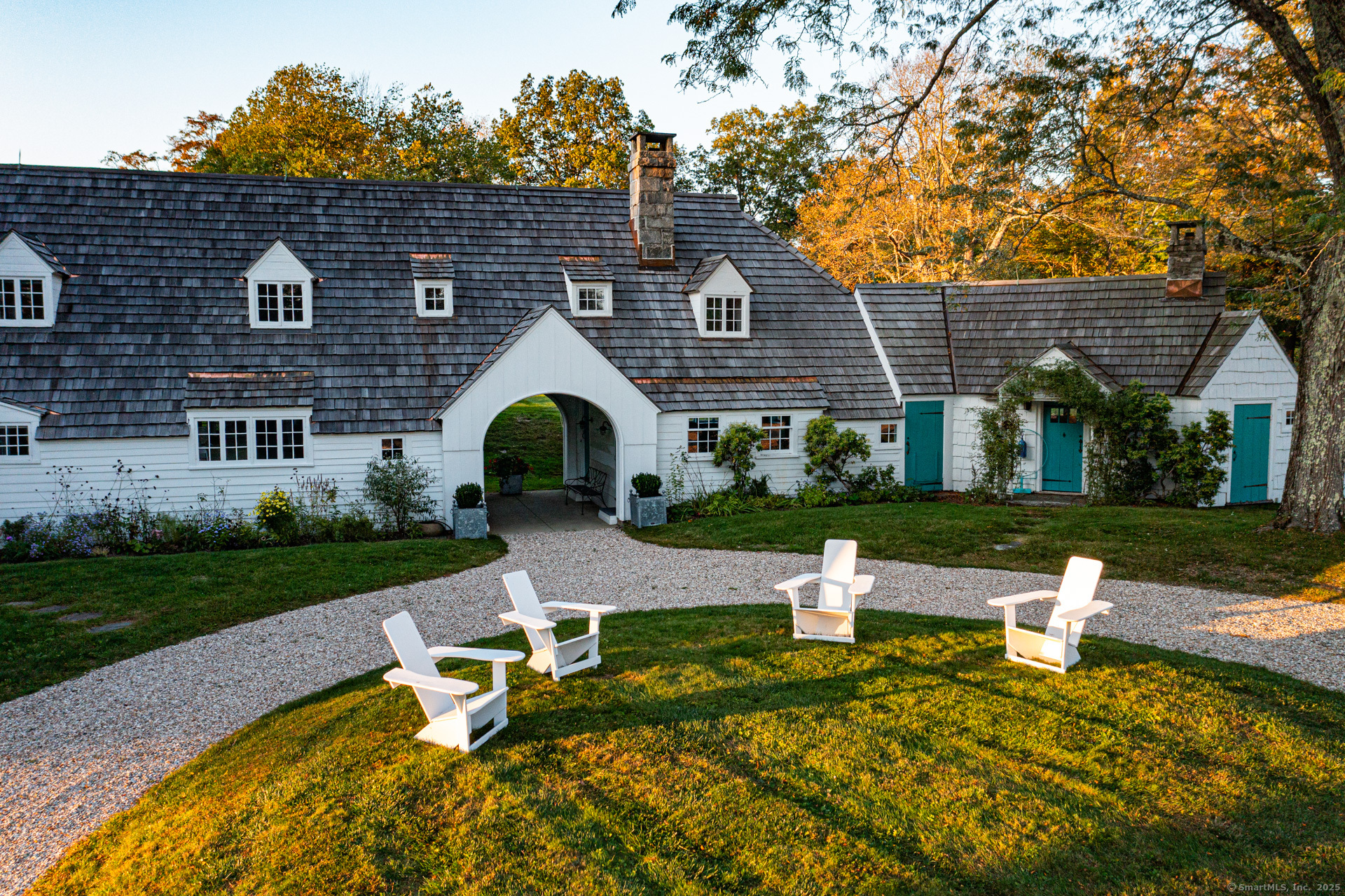 102 Melius Road Warren, CT 06754 - Photo 31 of 39 a front view of a house with garden and sitting area