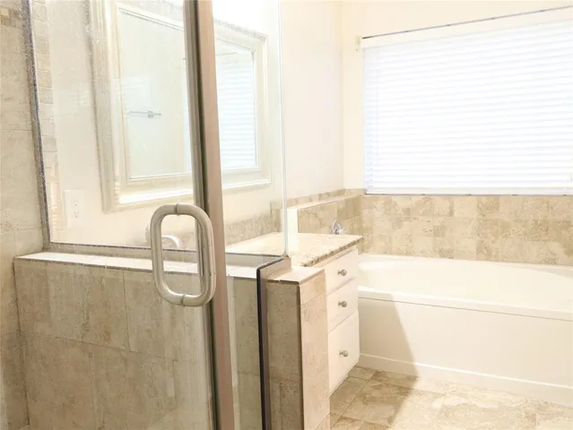 a bathroom with a bathtub and a shower