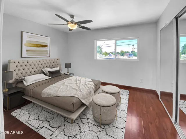a bedroom with a bed and wooden floor