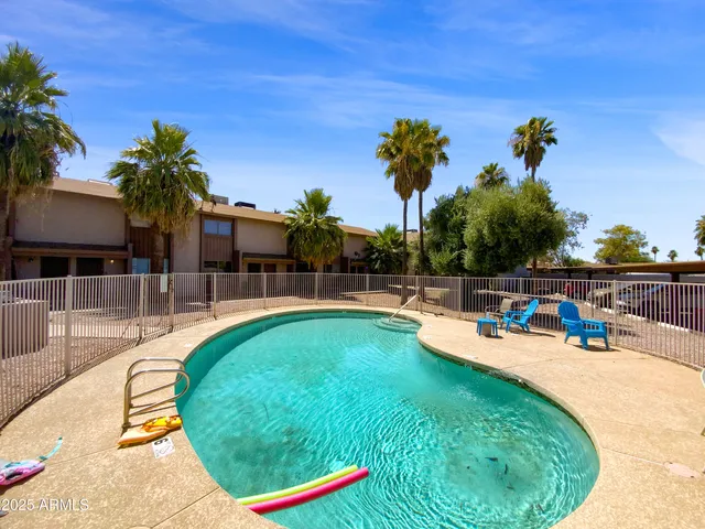 a view of a swimming pool with an outdoor seating