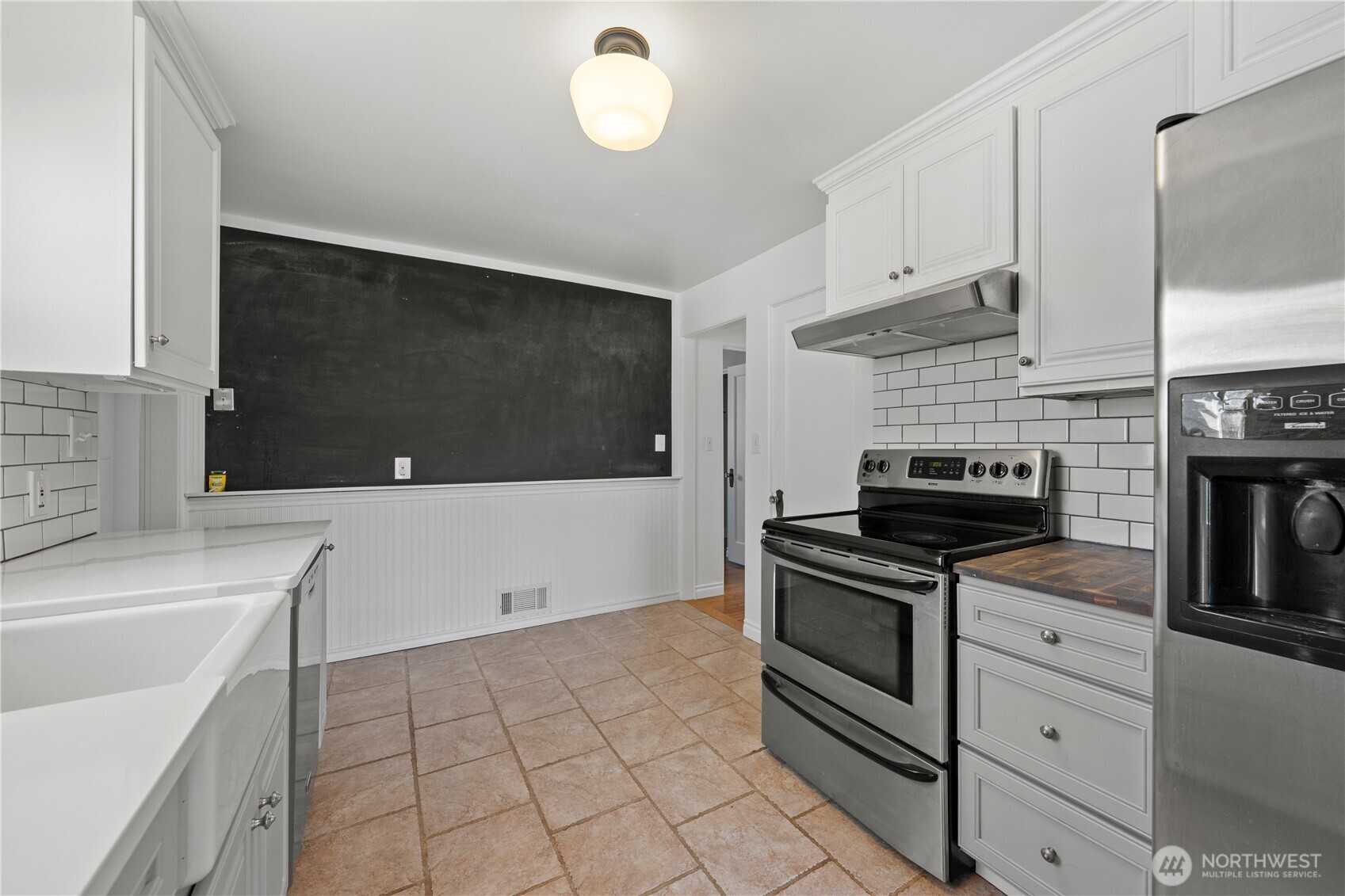 222 D Street Southwest Ephrata, WA 98823 - Photo 20 of 40 a kitchen with stainless steel appliances a stove a microwave and white cabinets