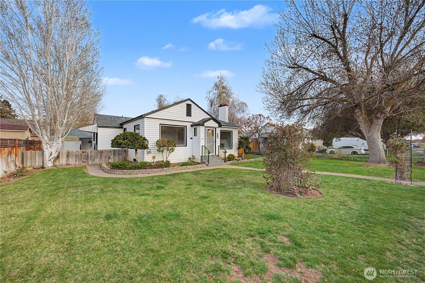 222 D Street Southwest Ephrata, WA 98823 - Photo 3 of 40 a view of a house with a big yard potted plants and large tree
