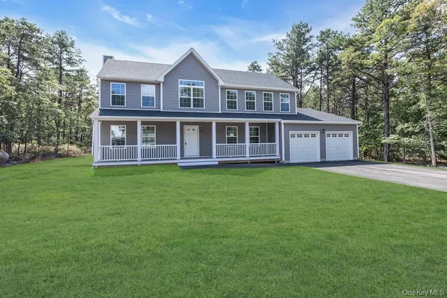 a view of a house with a yard and sitting area
