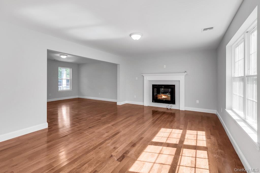 113 Currans Road Middle Island, NY 11953 - Photo 14 of 32 a view of an empty room with wooden floor and a window