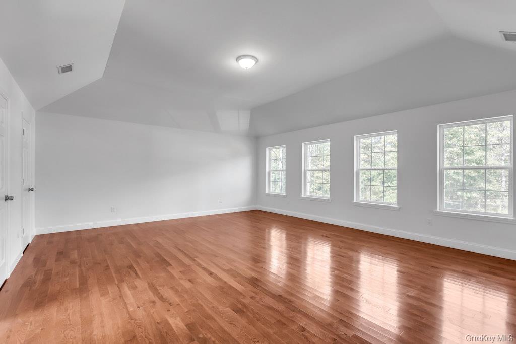 113 Currans Road Middle Island, NY 11953 - Photo 22 of 32 an empty room with wooden floor and windows