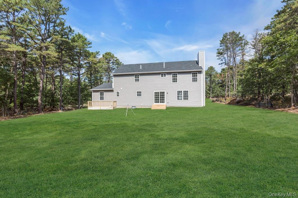 113 Currans Road Middle Island, NY 11953 - Photo 29 of 32 a view of a white house with a big yard with large trees