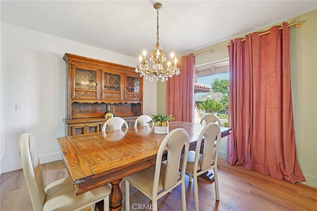 1500 Country Club Drive Riverside, CA 92506 - Photo 12 of 39 a dining room with furniture a chandelier and wooden floor