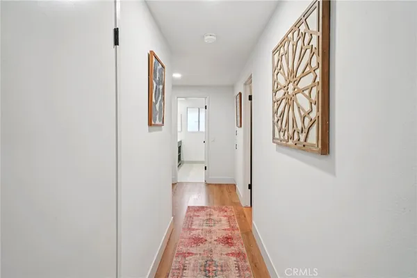 a bedroom with two beds and chair
