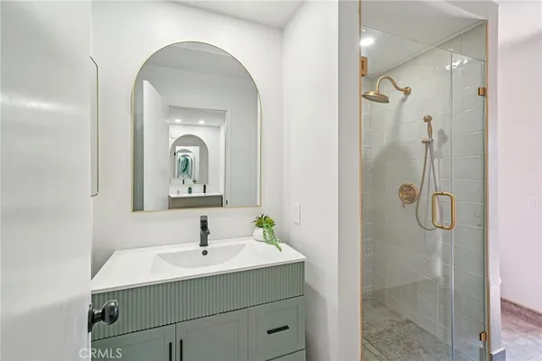 a bathroom with a glass shower door