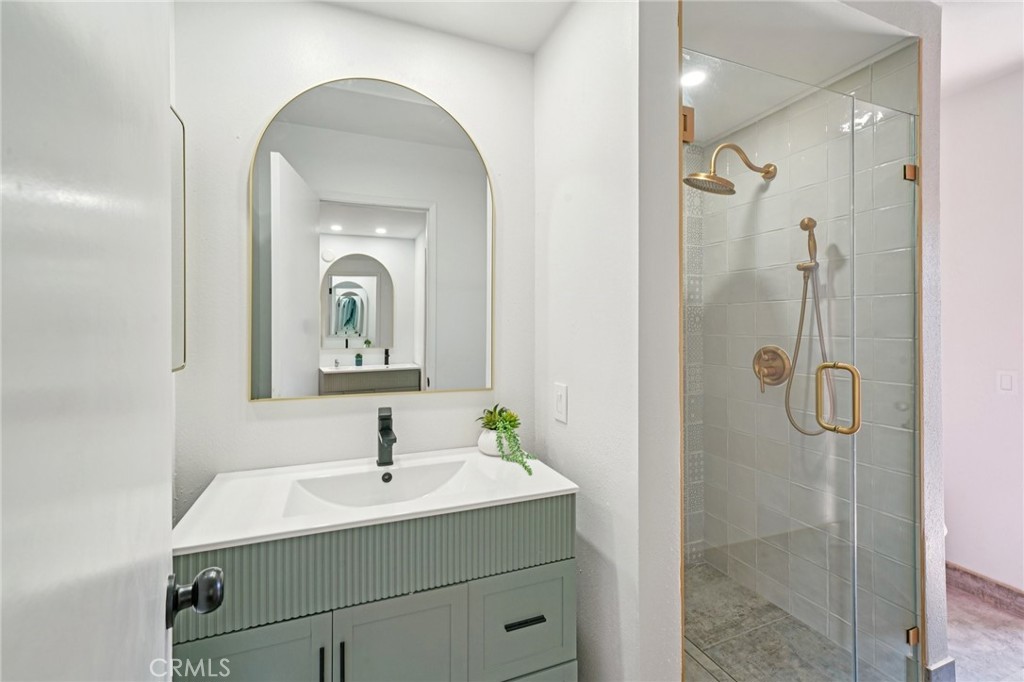 1500 Country Club Drive Riverside, CA 92506 - Photo 23 of 39 a bathroom with a sink a mirror and shower