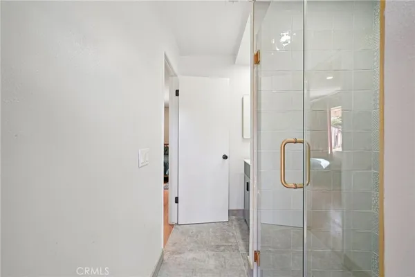 a spacious bedroom with a bed a dresser and mirror