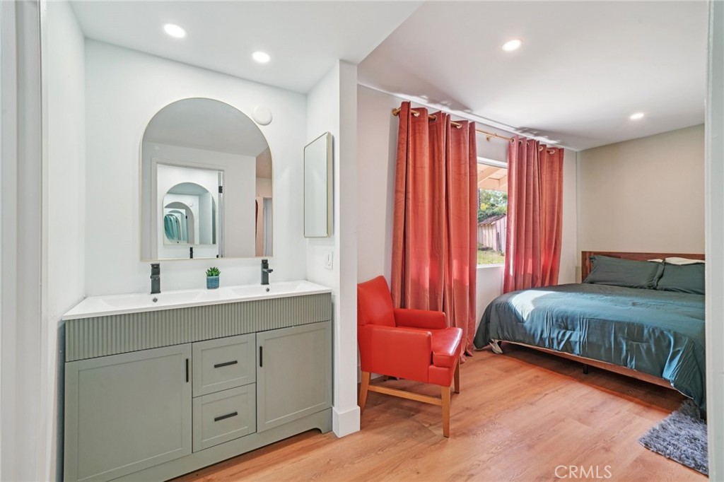 1500 Country Club Drive Riverside, CA 92506 - Photo 25 of 39 a spacious bedroom with a bed a dresser and mirror