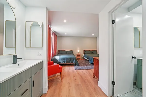 a bedroom with a bed and a mirror