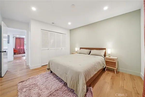 a bed room with a bed and a night stand