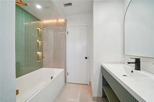 a bathroom with a double vanity sink and a mirror