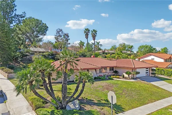 a aerial view of a house with swimming pool garden and patio