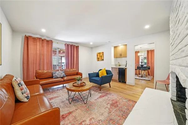 a dining room with furniture window and wooden floor