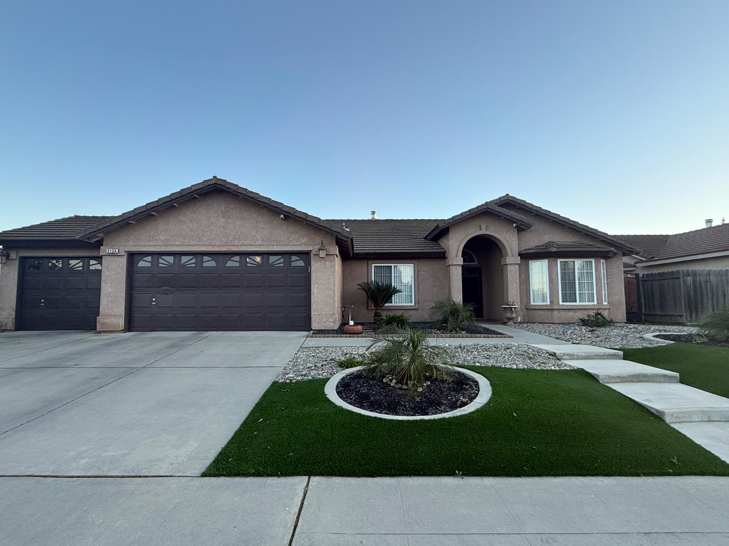 a house with yard and outdoor seating